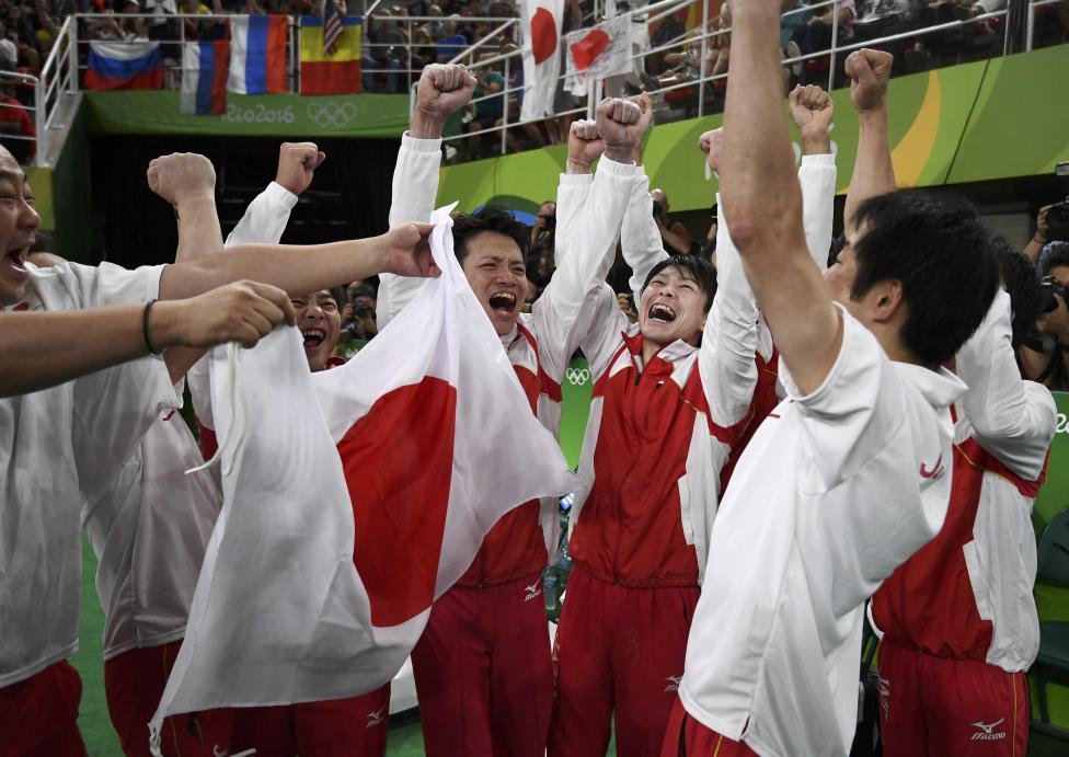 Japan gymnasts celebrate winning the men's gymnastics team final. REUTERS/Dylan Martinez